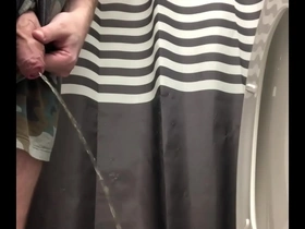 Uncut guy pissing and shaking out the drops