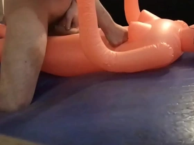 Pounding cheap female inflatable doll on blue waterbed mattress